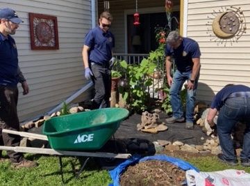 volunteers mulching a garden bed