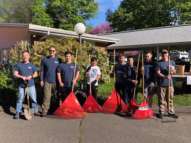 volunteers holding rakes